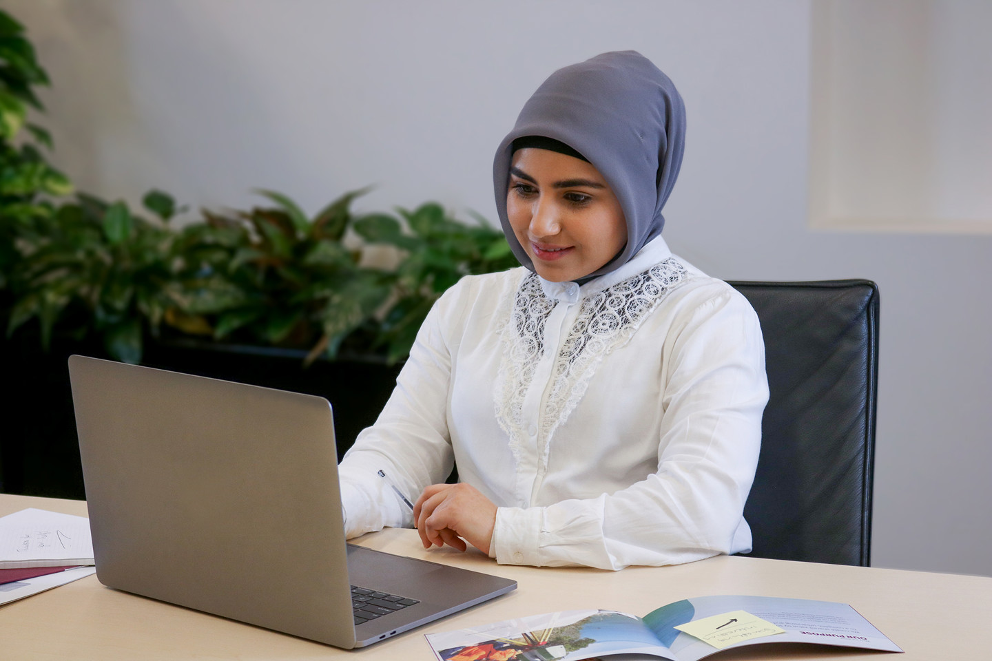 A woman working on a laptop computer