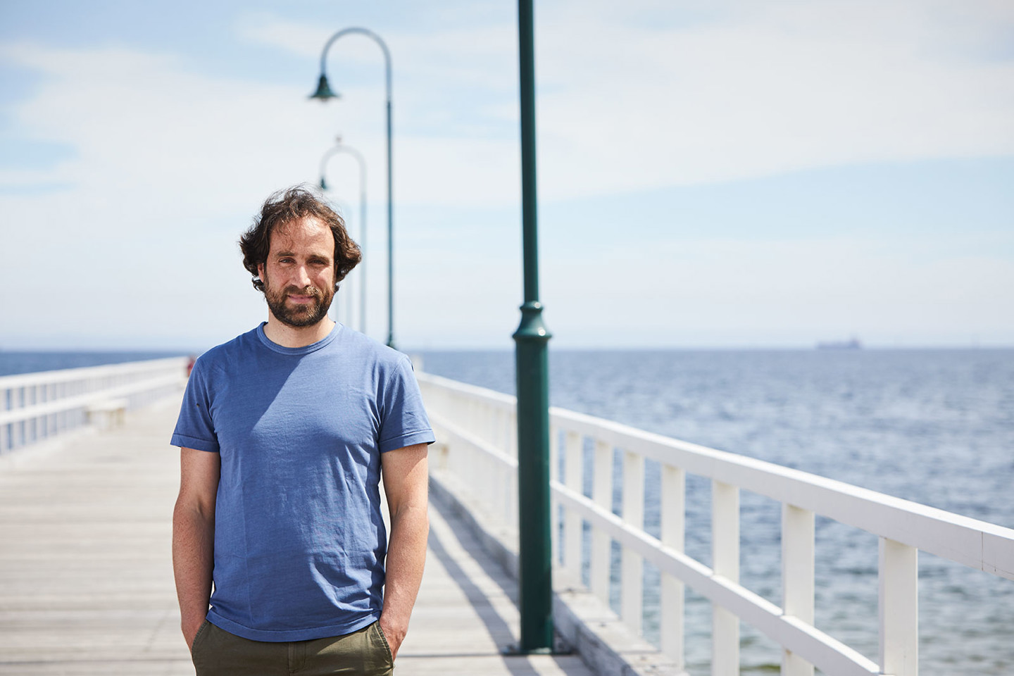 Peter Crockett, RPS Managing Scientist is standing on the Kerferd Road Pier in Albert Park Melbourne with Port Phillip Bay in the background.