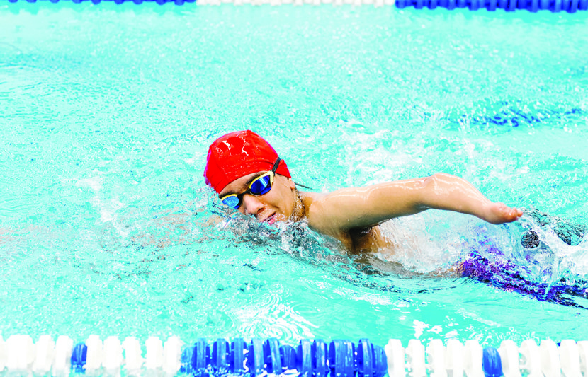 Swimmer with disability competes in swimming lane 